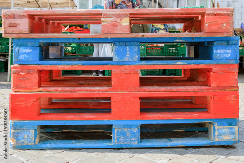 Pile of red and blue empty palettes on a market in Masstricht, Netherlands