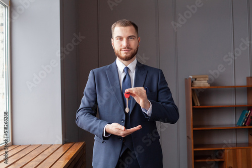 Man with keys. Businessman and real estate
