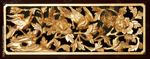 Golden birds and flower decorative.  Vintage door decor in penang. Antique peranakan wooden carving photo