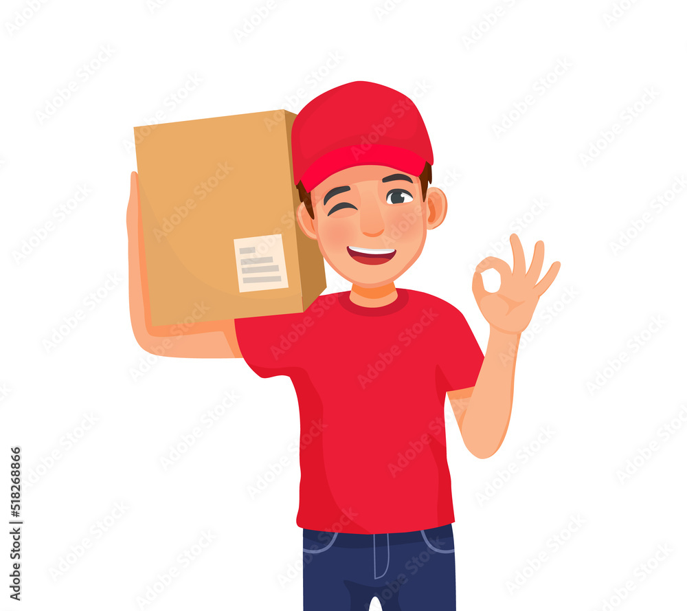 young delivery man or courier service with red cap uniform holding box package on his shoulder showing ok sign gesture