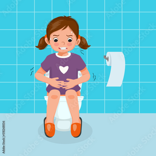 cute little girl sitting on toilet bowl in pain suffer from stomach ache having diarrhea constipation digestive problem