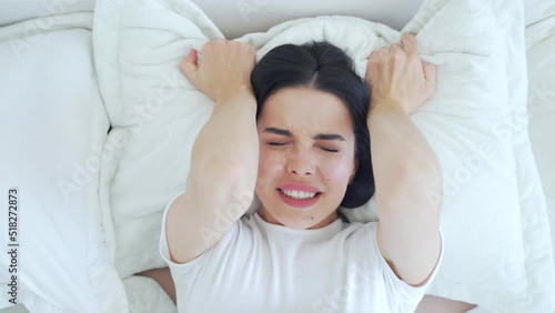 portrait Young beauty woman having orgasm in bed, top view. face horny excited hot female alone pleasures herself in the bedroom lying on the bed. beautiful sexy caucasian brunette holding a pillow