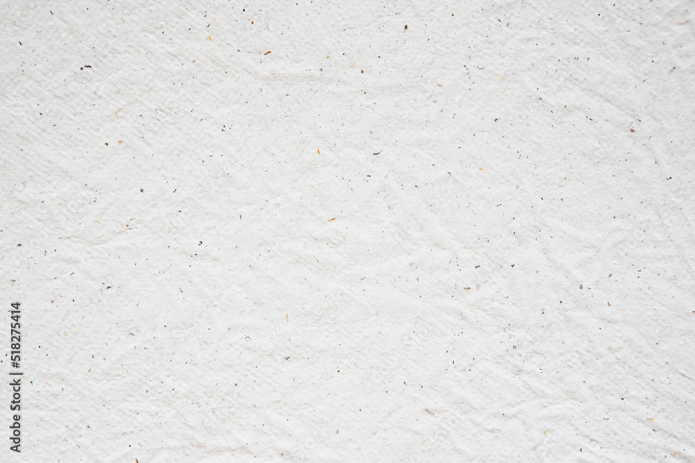 Obraz premium Blank white crumpled and creased paper. White sheet of crumpled paper glued to the wall. Beautiful abstract artistic white empty street poster paper texture pattern