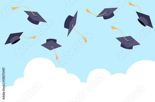 Flying students graduation hats in the blue sky