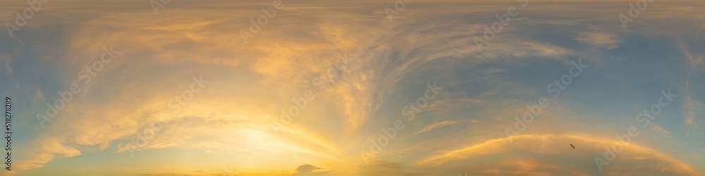 Golden glowing sunset sky panorama with Cirrus clouds. Hdr seamless spherical equirectangular 360 panorama. Sky dome or zenith for 3D visualization and sky replacement for aerial drone 360 panoramas.
