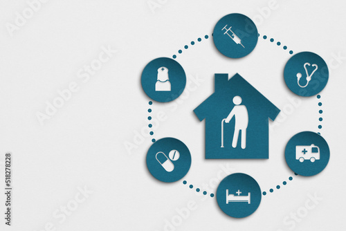 elderly nursing care concept, house blue paper cut with elderly person icon inside and health icon on grunge grey background including copy space