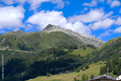 Mountain panorama seen from mountain village Airolo  Canton Uri  on a sunny summer day. Photo taken June 25th  2022  Airolo  Switzerland.