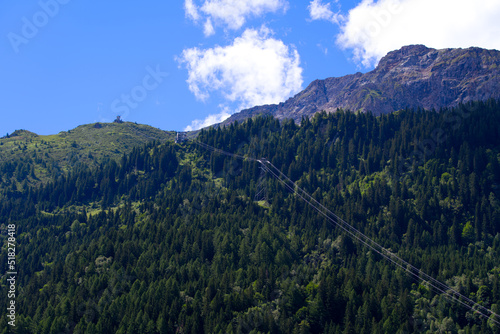 Cable car at mountain village Airolo, Canton Ticino, with woodland on a sunny summer day. Photo taken June 25th, 2022, Airolo, Switzerland.