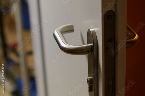 Metal handle on plastic door close up