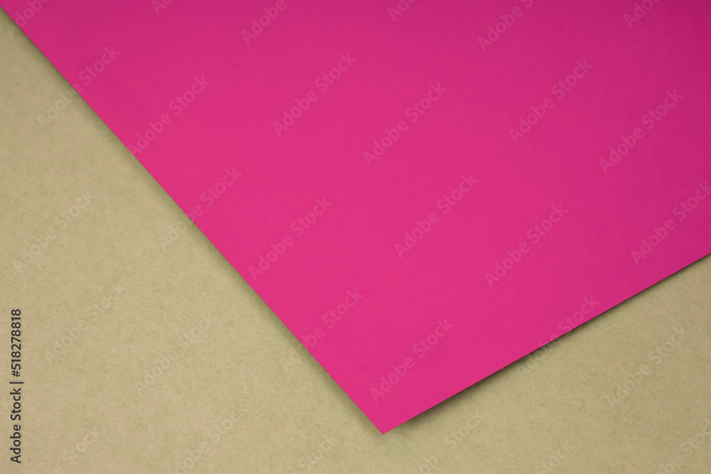 Plain pink n paper sheet lying on brown yellow textured Background like an open book from top angle