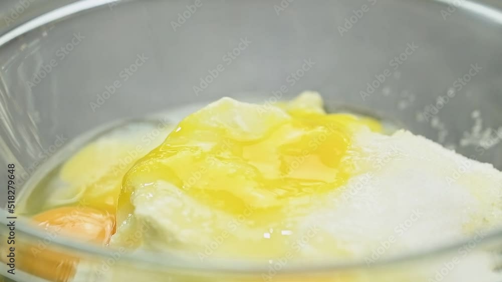 Adding egg to the mixture . Process of making dough.
Adding egg to the mixture . Process of making dough.