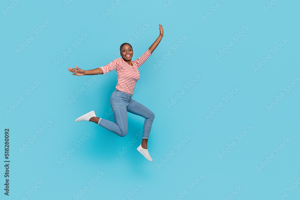 Full body photo of overjoyed cheerful lady jump have fun good mood isolated on blue color background