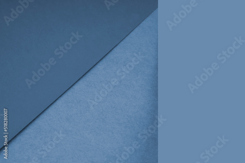 Textured and plain blue sheet papers forming two triangles and vertical blank rectangle for creative cover designing