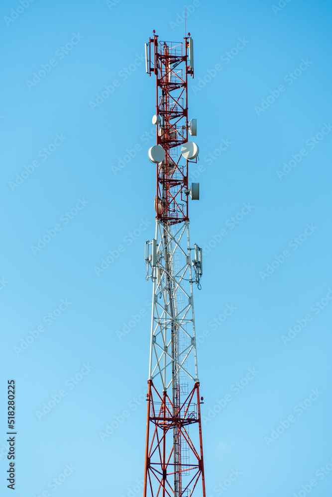 New GSM antennas on a high tower against a blue sky for transmitting a 5g signal are dangerous to health. Radiation pollution of the environment through cell towers. The threat of extinction New GSM antennas on a high tower against a blue sky for transmitting a 5g signal are dangerous to health. Radiation pollution of the environment through cell towers. The threat of extinction