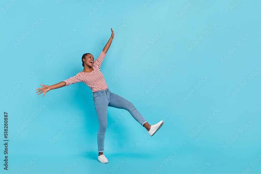 Full size portrait of satisfied positive person raise hands look empty space good mood isolated on blue color background