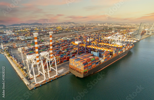 Photography cargo ship and truck at seaport waiting for container dock crane shipment harbor loading container import and export commercial trade business logistic and transportation international