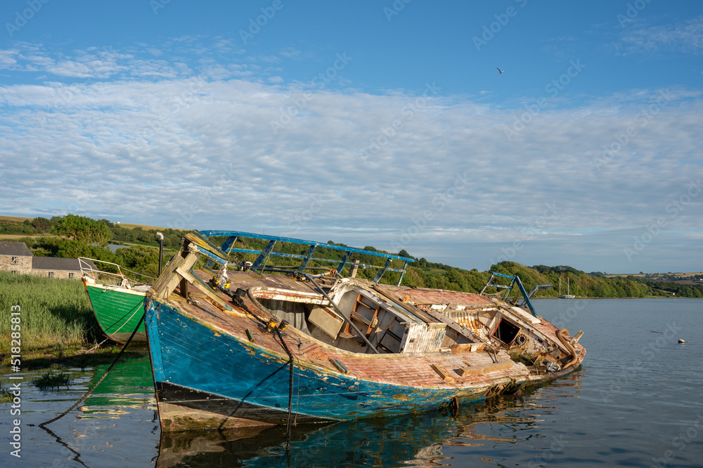 old derelict fishing boat being broken down in breakers yard wales UK old derelict fishing boat being broken down in breakers yard wales UK
