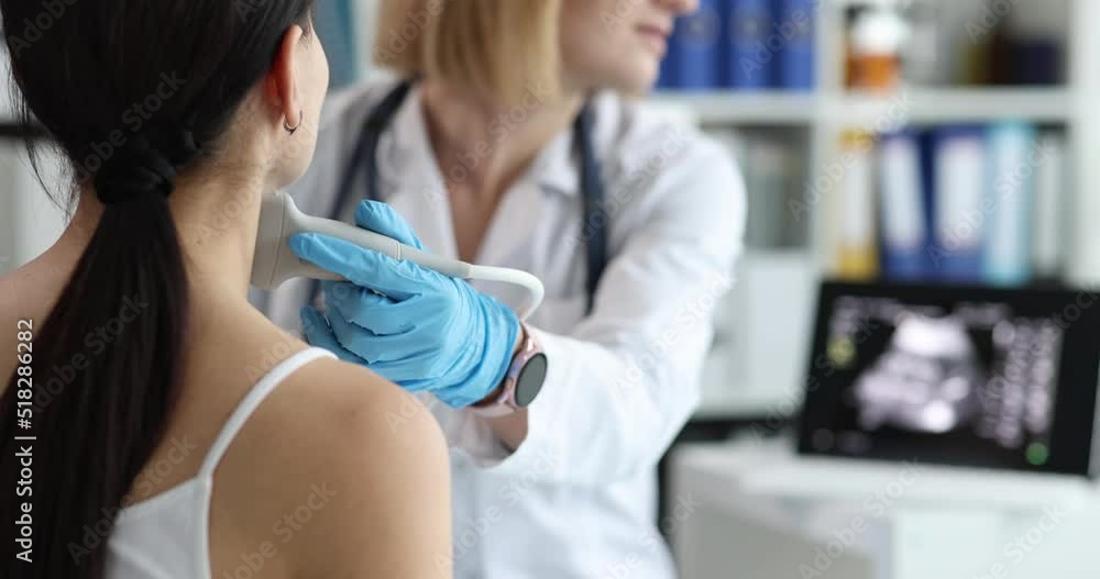 Doctor's hands with a probe on a woman's neck Doctor's hands with a probe on a woman's neck