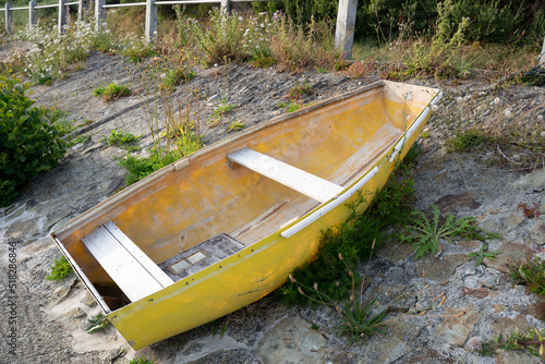 small yellow fishing boat on the banks of the river Teifi in cardigan west wales photo