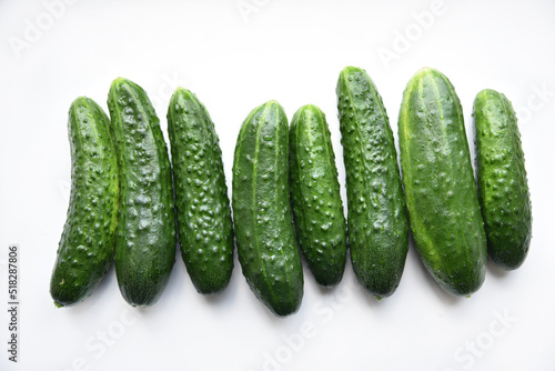 Green juicy cucumbers on a white background.