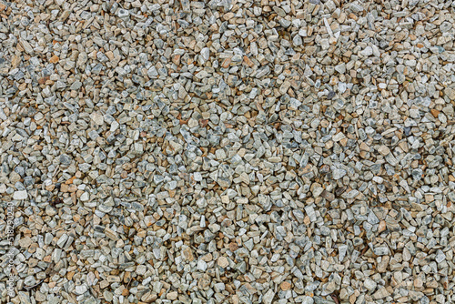 Gravel background, small granite stone. Construction material for building walls and fences.