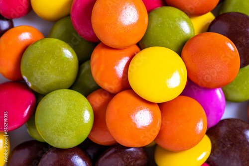 Colorful candies or bonbon. Top view of a pile of candies with chocolate filling. close up © enezselvi