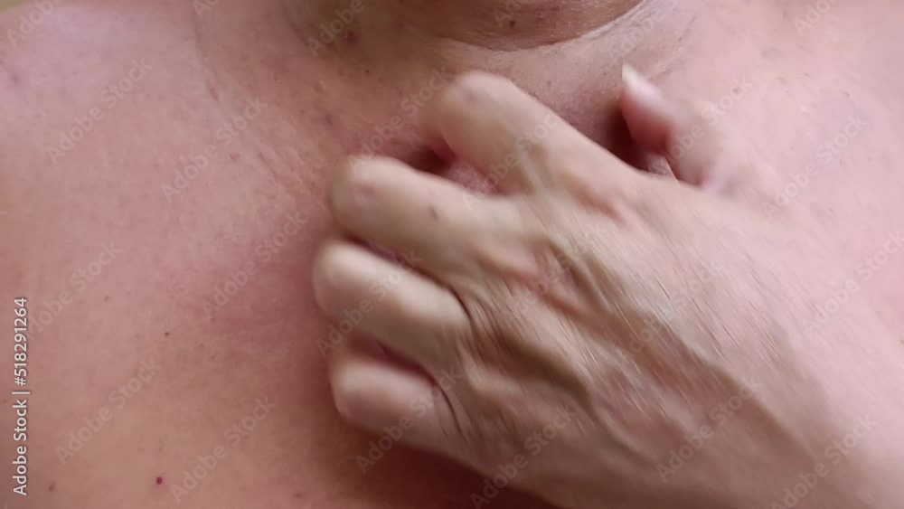 Man's hand scratching his chest. Man's hand scratching his chest.