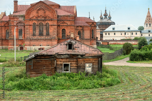 Yuryev-Polsky, Russia - August 10, 2021: Old ruined wooden private house. Yuryev Kremlin (Archangel-Mikhailovsky Yuryevsky Monastery), the city of Yuryev-Polsky. Vladimir region, Russia photo