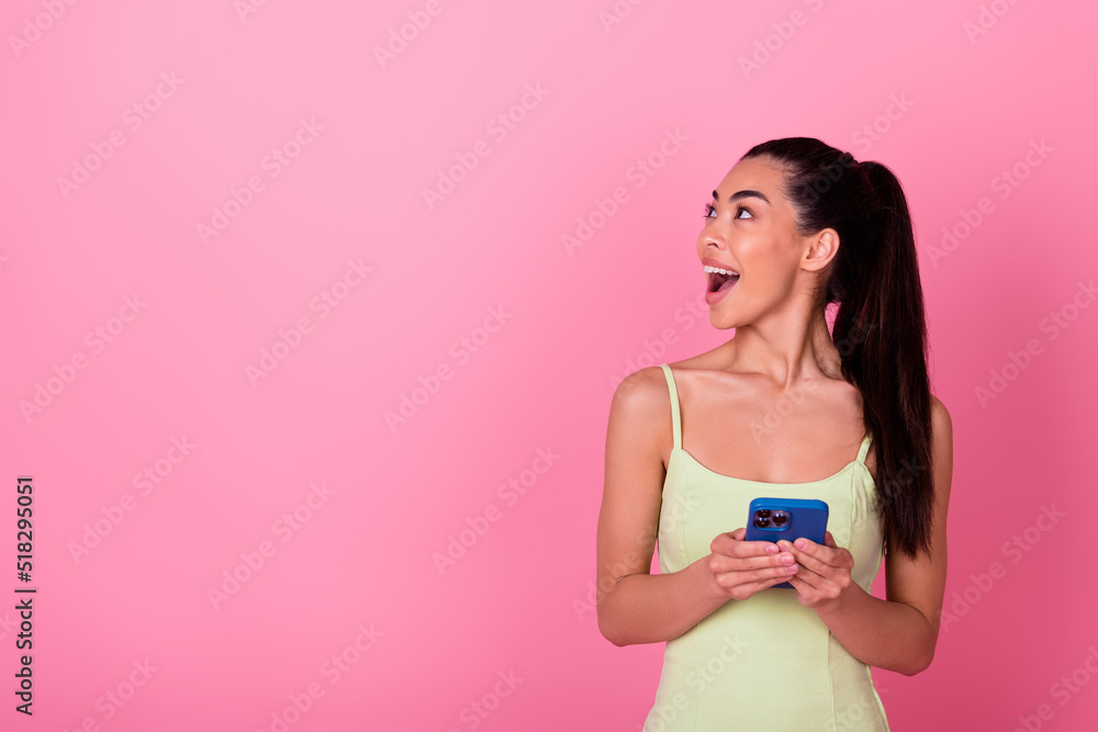 Photo of funky dreamy girl dressed yellow sarafan looking empty space chatting modern device isolated pink color background Photo of funky dreamy girl dressed yellow sarafan looking empty space chatting modern device isolated pink color background
