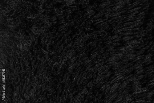 Faux fur black wool abstract pattern nature skin soft warm fluffy background dark artifical texture