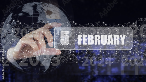 February 5th. Day 5 of month, Calendar date. Hand hold virtual screen card with calendar date. Winter month, day of the year concept.