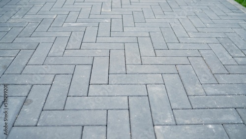 Trowel for laying floor tiles. Alignment of sand mortar on paving stones. Fine sand is poured into the cracks of paving slabs.