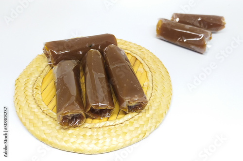 Dodol is a traditional snack from Indonesia with a sweet taste. Isolated on a white background photo