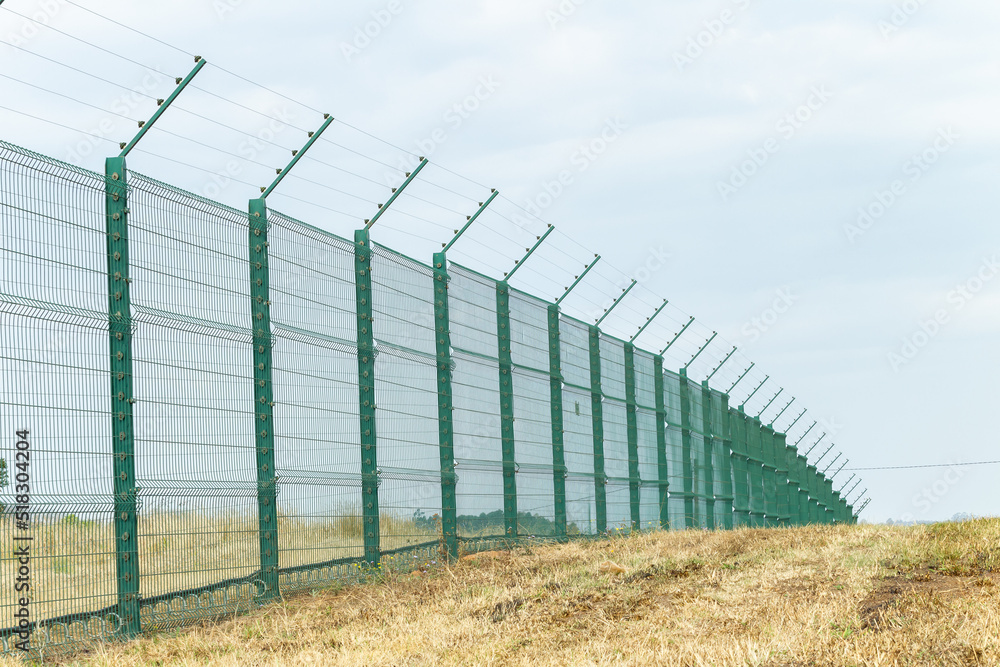 New Steel Fence with Electrified Wires for security on boundary of Private Property. New Steel Fence with Electrified Wires for security on boundary of Private Property.