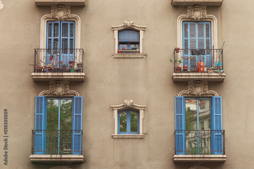 Six old window with blue wooden shutters. Reflection in glass. Barcelona, Catalonia Spain