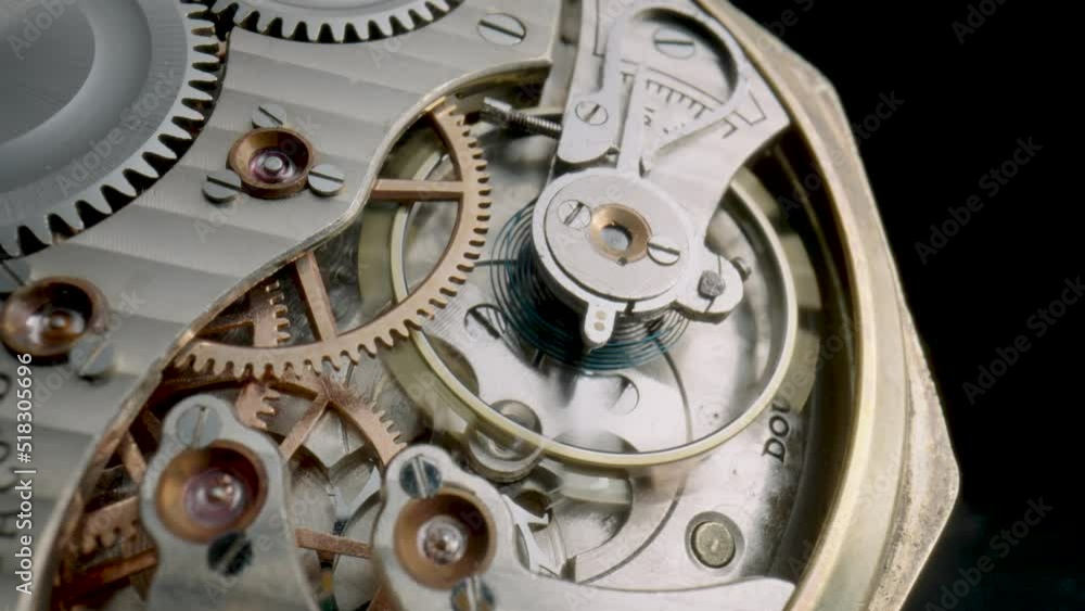 Antique pocket watch mechanism moving on isolated black studio ...