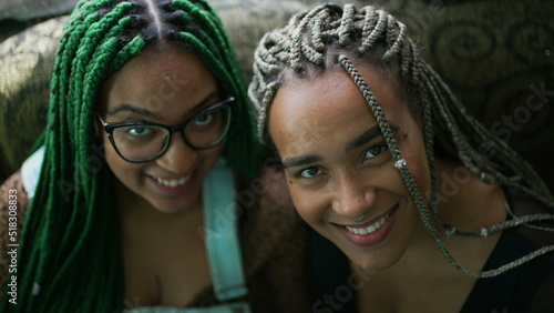 Two black latina young women portrait faces looking at camera