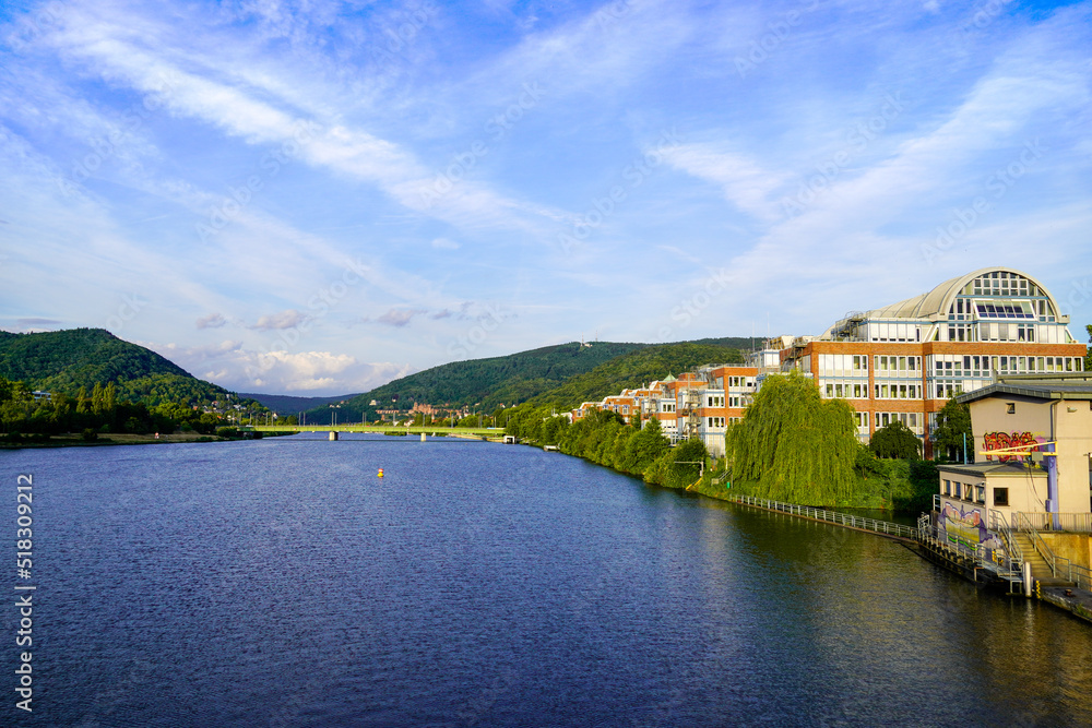View of the Neckar and Heidelberg from the Wehrsteg Wieblingen. Weir on the Neckar. Pedestrian and bike path.

