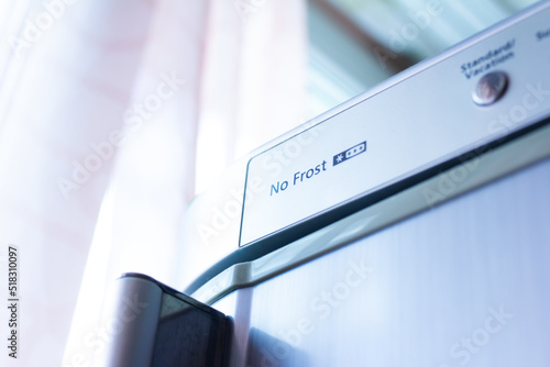 The inscription no frost on the body of the refrigerator close-up, selective focus