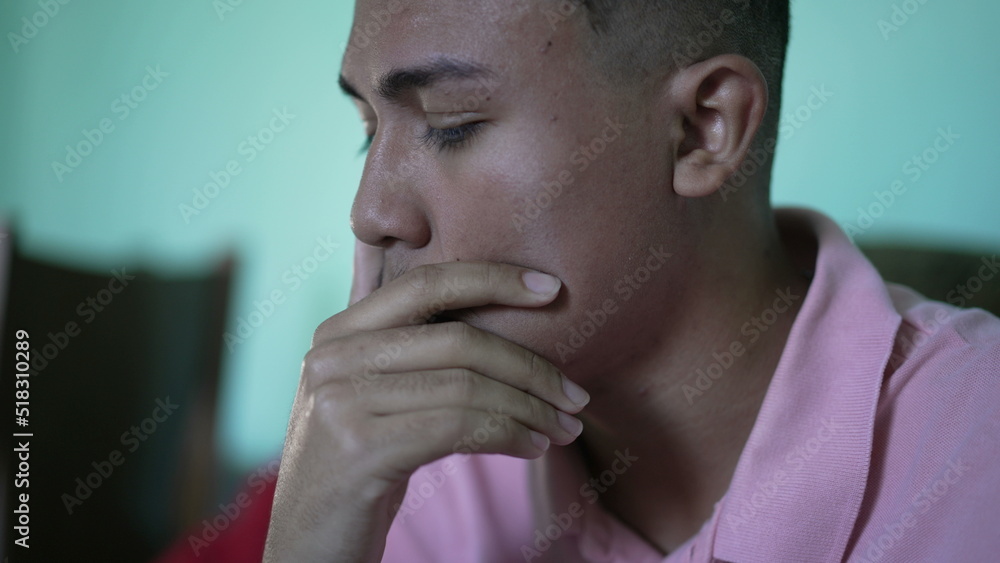 One anxious hispanic young man covering face with regret emotion One anxious hispanic young man covering face with regret emotion