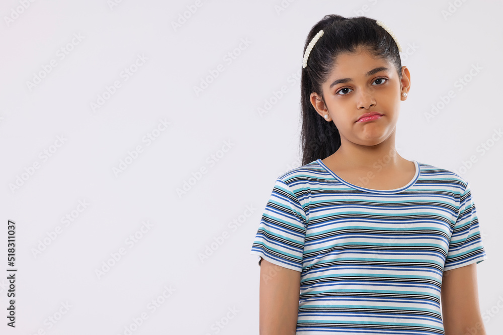 Portrait of a sad girl standing against white background Portrait of a sad girl standing against white background