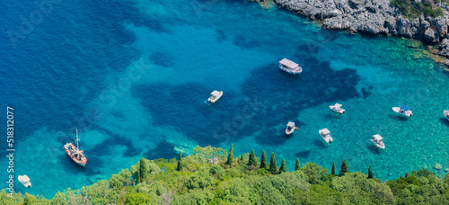 Aerial view of boats close to Limni Beach Glyko, on the island of Corfu. Greece. Where the two beaches are connected to the mainland providing a wonderful scenery. Unique double beach. 