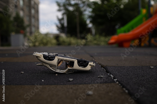 a broken children's toy is lying on the Playground, a broken toy car. War in Ukraine. 