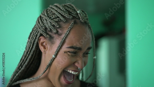 A black latina young woman spontaneous laugh and smile