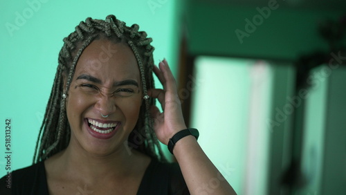 A black latina young woman spontaneous laugh and smile