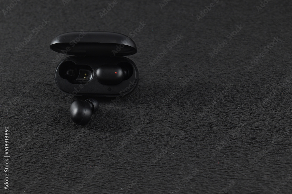 black wireless headphones with a black background