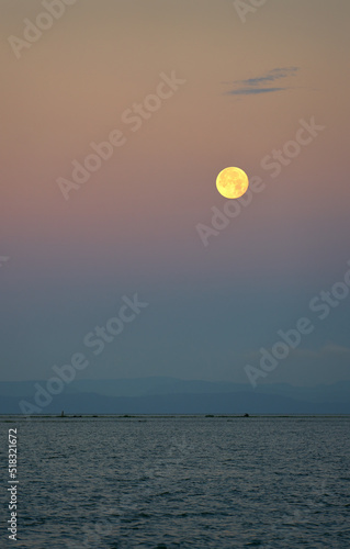 Salish Sea Moonset. Moonset over the Salish Sea Strait of Georgia. Vancouver Island lies on the horizon.   