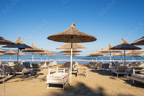 Beach umbrellas from the sun and sun loungers on the beach.