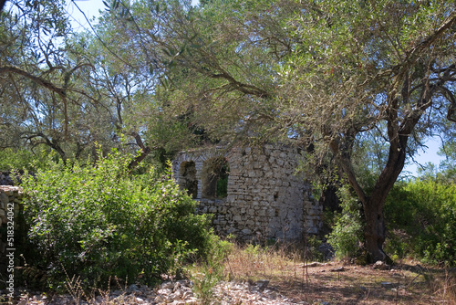 The picturesque ruins of the tiny early Christian church of Agios Stefanos, forgotten in the midst of olive groves near Ozias, Paxos, Ionian Islands, Greece