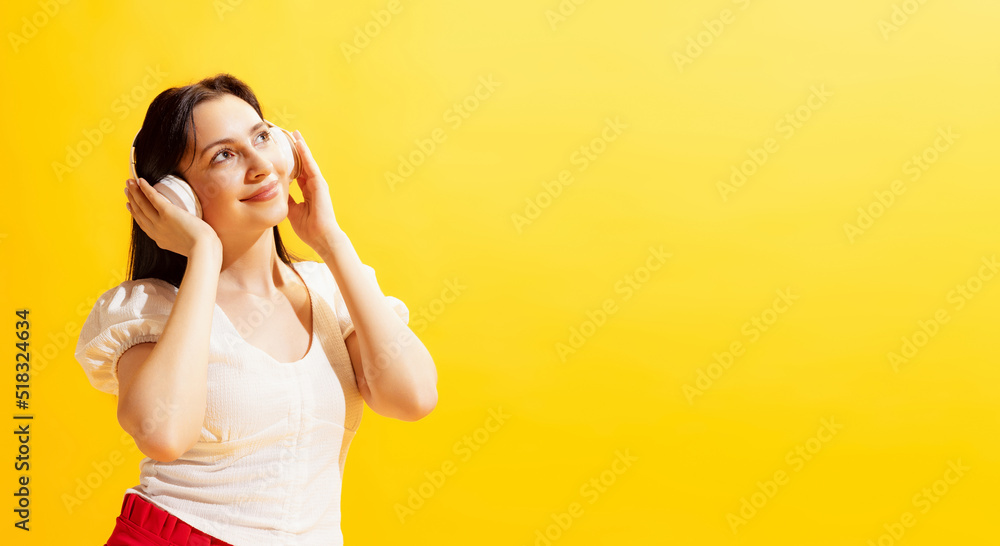 Studio shot of young beautiful woman in summer casual style outfit isolated on bright yellow background. Concept of beauty, art, fashion, human emotions